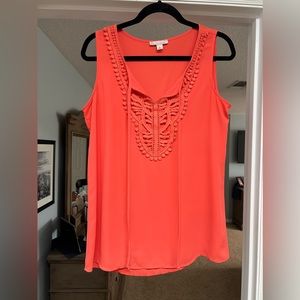 Light orange/coral colored sleeveless top